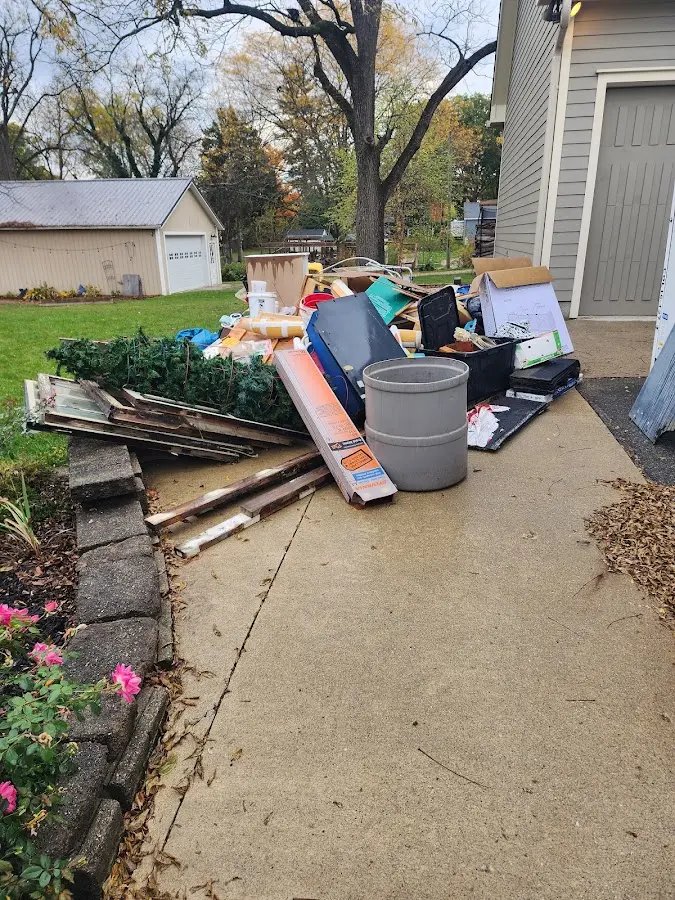 Dumpster being loaded with debris for 3 Yard Dumpster Rental in Tarboro